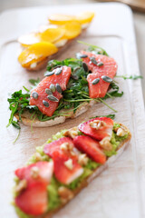 Close view of delicious sweet Bruschetta (sandwiches) with different tastes on a wooden cutting board 