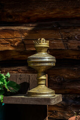 Fototapeta na wymiar Old kerosene lamp on the background of a wooden wall