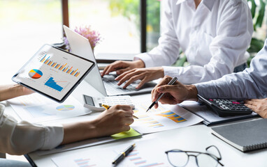 business people meeting in the office Calculate the tax and income of the company's investment....