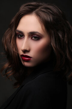 Photo of beautiful young girl with makeup on black background