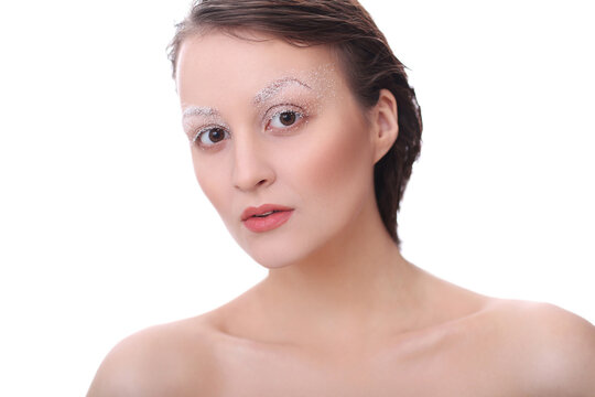 A photo of a young beautiful woman model with white brows makeup posing for camera