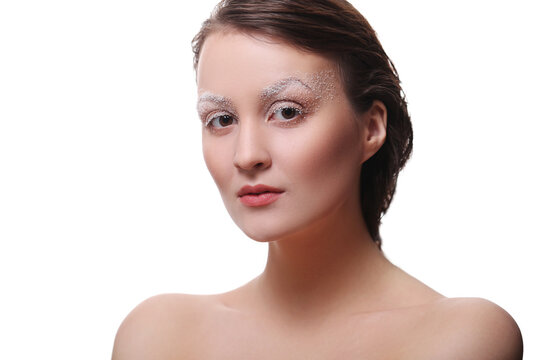 A photo of a young beautiful woman model with white brows makeup posing for camera