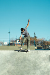 Skater doing trick on skate park concrete bowl