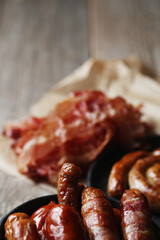 Delicious homemade hot grilled sausage on a wooden background