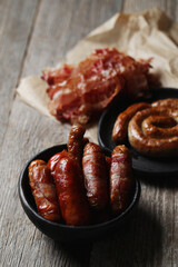 Delicious homemade hot grilled sausage on a wooden background