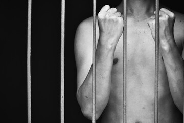 prison man crime in gaol raised his fist and two arms demonstrates confidence and courage.concept for prisoner,hopeness,detain,erroneousness