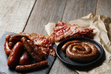 Delicious homemade hot grilled sausages on a wooden background