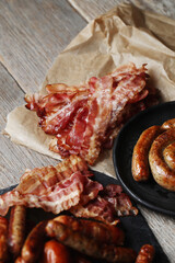 Delicious homemade hot grilled sausage on a wooden background