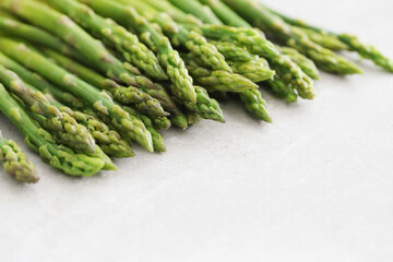 Bunch of fresh tasty green asparagus on a light surface