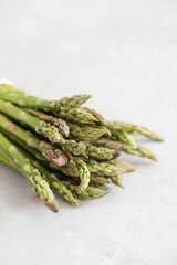 Bunch of fresh tasty green asparagus on a light surface