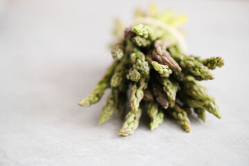 Bunch of fresh spring green asparagus on a light surface