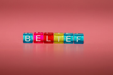 The word "belief" made up of cubes