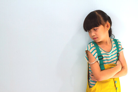 Asian little girl thoughtful unhappy emotion concept