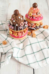 Top view of delicious sweet donuts with ice cream on top of the plate