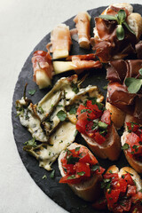 A set of delicious fresh mini sandwiches with vegetables on a wooden surface