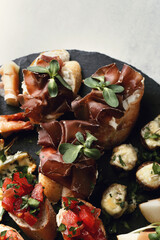 A set of delicious fresh mini sandwiches with vegetables on a wooden surface