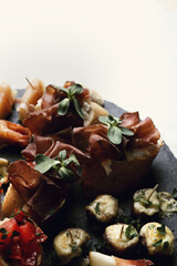 A set of delicious fresh mini sandwiches with vegetables on a wooden surface