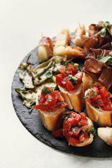 Delicious snacks of breads with vegetables on the holiday table