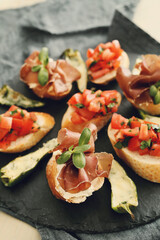 Delicious snacks in the form of mini sandwiches with meat and vegetables for the party