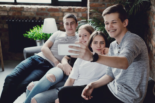 Group of friends taking selfie picture smiling at camera