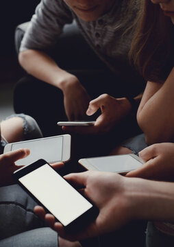 Group of friends having fun with smartphones