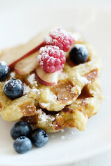 Breakfast of tasty mini Waffles with berries on a white plate