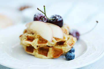 Mini Waffles with berries for the breakfast on a white plate
