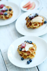 Mini Waffles with berries for the breakfast on a white plate