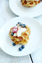 Mini Waffles with berries for the breakfast on a white plate