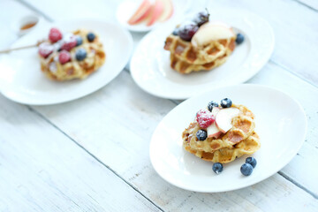 Mini Waffles with berries for the breakfast on a white plate