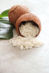 Composition with coconuts and  green leaves on a marbel surface