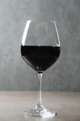 Side view photo of one glass of red wine 