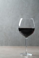 Image of one glass of red wine on a dark surface