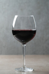 Image of one glass of red wine on a dark surface