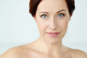 Fototapeta premium Close-up portrait of a beautiful,mature woman with blue eyes looking into the camera 