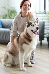 Beautiful woman posing with her dog Husky at home  © racool_studio