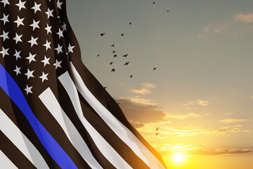 American flag with police support symbol Thin blue line on sunset sky with birds. Police in society...