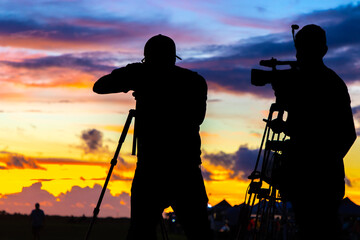 Movie camera crew films sunrise