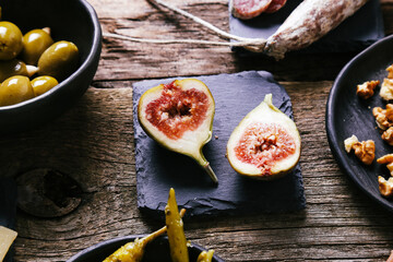 Delicious food with figs on a wooden surface.