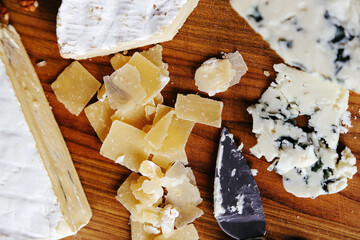 Fresh camembert cheese with sliced camembert on a wooden surface.