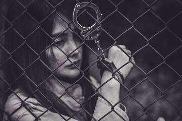 Portrait of women desperate to catch the iron prison,prisoner concept,thailand people,Hope to be...