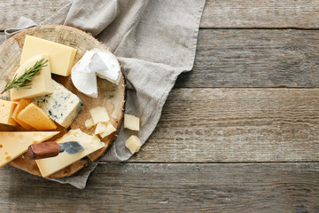 Different kinds of cheese isolated on a wooden surface.