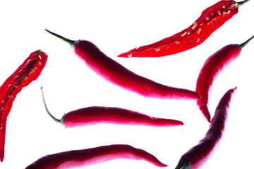 Flying red chili peppers isolated on a white background.