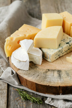Different kinds of cheese isolated on a wooden surface.