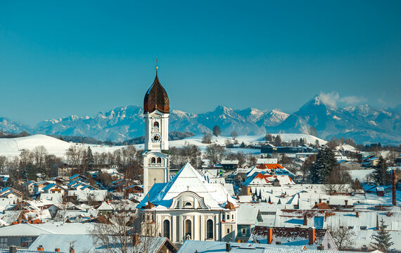 Saint Andreas church in Nesselwang with alpine panorama in background