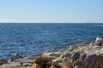 Fototapeta na wymiar Big rocks at coastline of Marbella, Spain