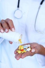 Many tablets of various medicinal drugs in the hand