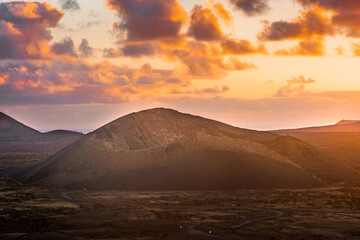 Fototapeta na wymiar Amazing sunset over El Cuervo Volcano, in Lanzarote, Canary Islands, Spain