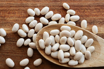 white beans on a wooden background