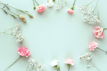 Top view of floral composition with pink roses on a blue background.
